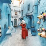 young-woman-with-red-dress-visiting-the-blue-city-chefchaouen-marocco.jpg